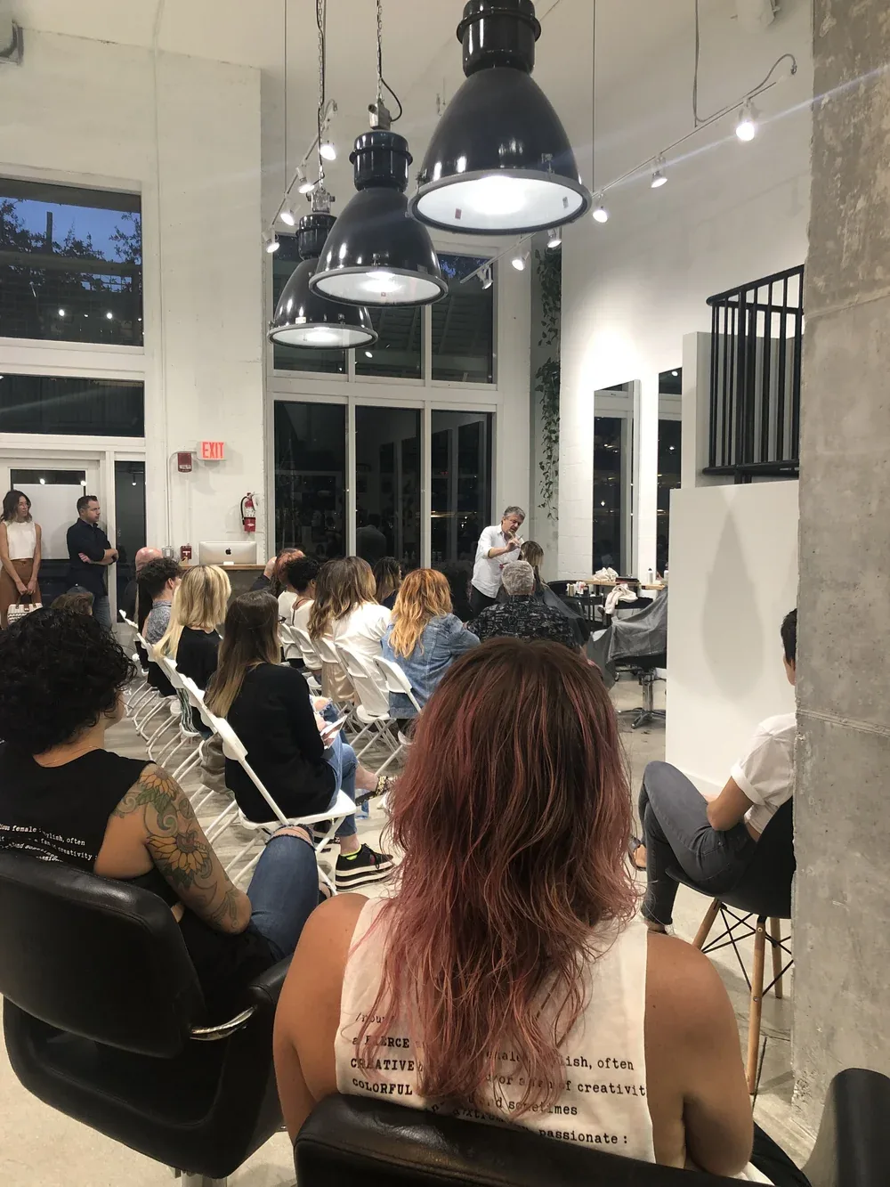 A packed seminar audience on the double-height studio floor.