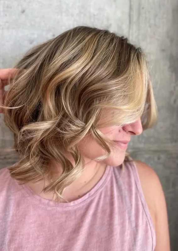 Highlighted blonde lob with a bouncy round-brushed blowout.