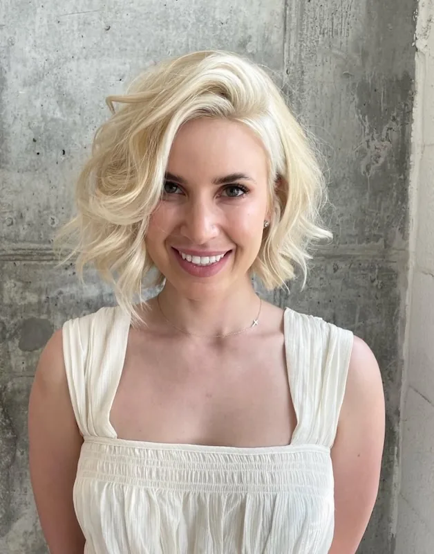 Bright platinum blonde bob in soft waves.