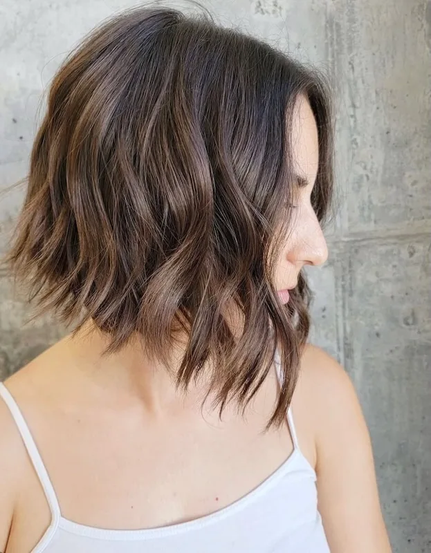 Chocolate brunette textured lob with soft undone bend.