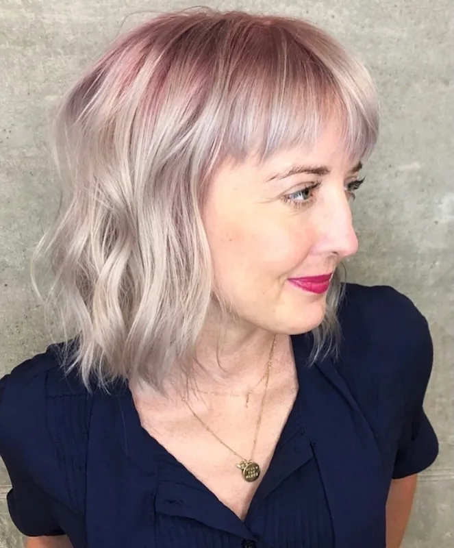 Silvery lavender-blonde shag with a soft fringe, toned to a pearl finish.
