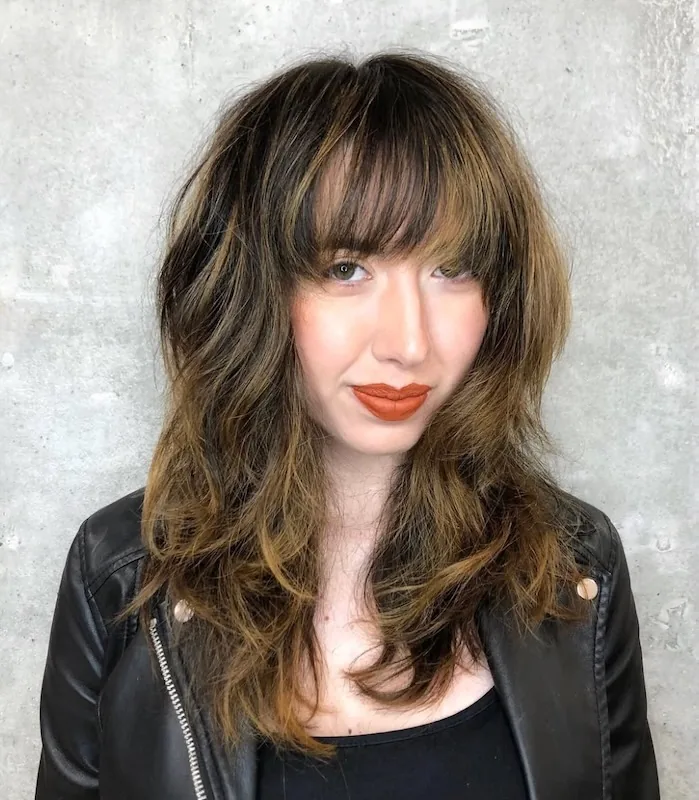 Dark shag with a heavy fringe and caramel-lit ends.