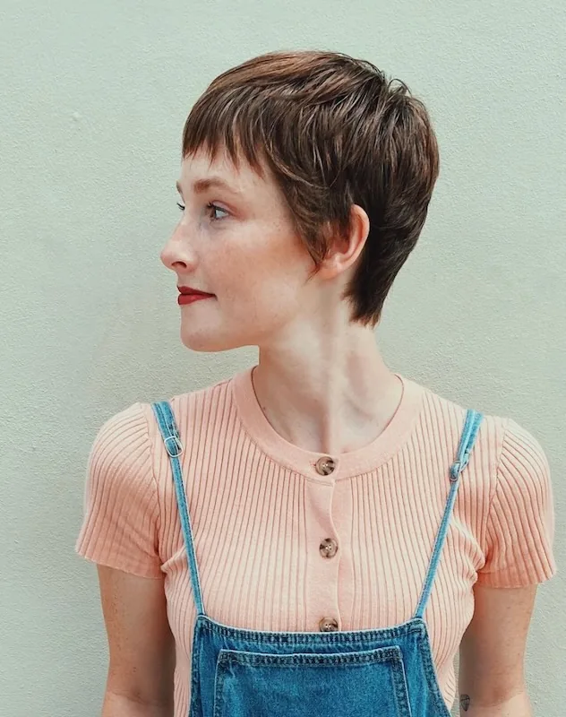 Textured brunette pixie with a micro fringe.