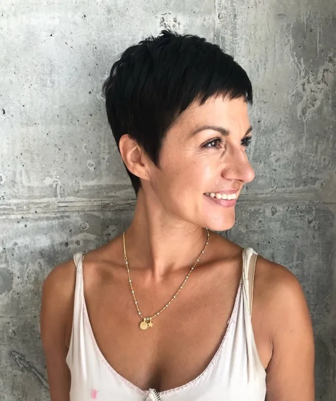 Cropped jet-black pixie, clean at the nape.