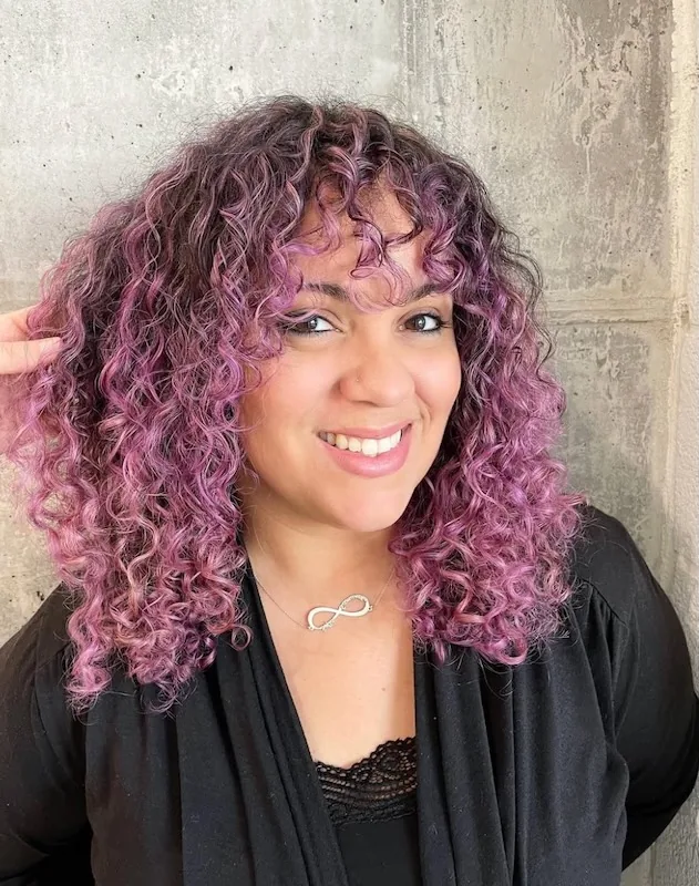 Orchid-purple color melted through natural curls with a curly fringe.